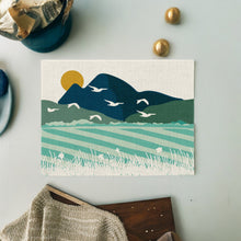 Load image into Gallery viewer, Single placemat on a pale green table with a Mountains and fields design.Wholesale Over the fields Placemats (Set of Four) - Mustard and Gray Trade Homeware and Gifts - Made in Britain