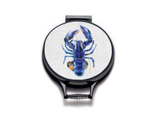 Load image into Gallery viewer, blue lobster watercolour painting on a beige linen circular aga cover with black hemming. Pictured on metal aga lid on an isolated background. Mustard and Gray