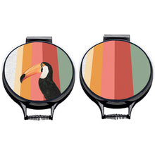 Load image into Gallery viewer, Set of two. Toco Toucan illustration printwith stripes of green, red, pink and orange on beige linen circular aga cover with black hemming. Aga chef's pad hob cover. Pictured on metal aga lid on an isolated background. Mustard and Gray