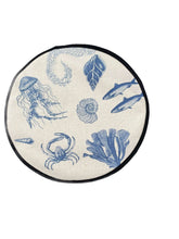 Load image into Gallery viewer, blue illustrations of sealife including fish, seaweed, shells, crabs, jelly fish, and fossilson a beige linen circular aga cover with black hemming.  Mustard and Gray
