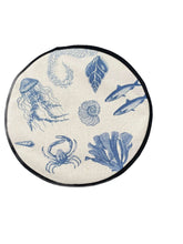 Load image into Gallery viewer, blue illustrations of sealife including fish, seaweed, shells, crabs, jelly fish, and fossilson a beige linen circular aga cover with black hemming. Mustard and Gray