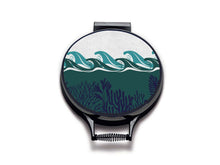 Load image into Gallery viewer, colourful green waves and navy seaweed print on a beige linen circular aga cover with black hemming. Pictured on metal aga lid on an isolated background. Mustard and Gray