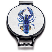 Load image into Gallery viewer, blue lobster watercolour painting on a beige linen circular aga cover with black hemming. Pictured on metal aga lid on an isolated background. Mustard and Gray