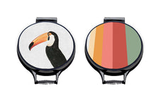 Load image into Gallery viewer, Set of two hob covers. Toco Toucan illustration print on a beige linen circular aga cover with black hemming. Stripes of Green, red, Pink and orange on one aga chef's pad and fish tail of the other aga chef's pad. Pictured on metal aga lid on an isolated background. Mustard and Gray