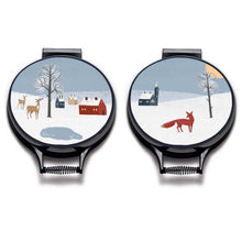 Load image into Gallery viewer, Set of 2. winter fox scandi modern print on a beige whith village scene including blue sky, a red fox, deer houses, church and pond linen circular aga cover with black hemming. Pictured on metal aga lid on an isolated background. Mustard and Gray
