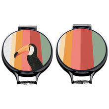 Load image into Gallery viewer, Set of two. Toco Toucan illustration printwith stripes of green, red, pink and orange on beige linen circular aga cover with black hemming. Aga chef&#39;s pad hob cover. Pictured on metal aga lid on an isolated background. Mustard and Gray
