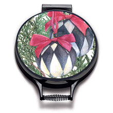 Load image into Gallery viewer, Illustration of Christmas tree bows with lack and white baubles with red bows,xmas decorations on linen circular aga cover with black hemming. Pictured on metal aga lid on an isolated background. Mustard and Gray

