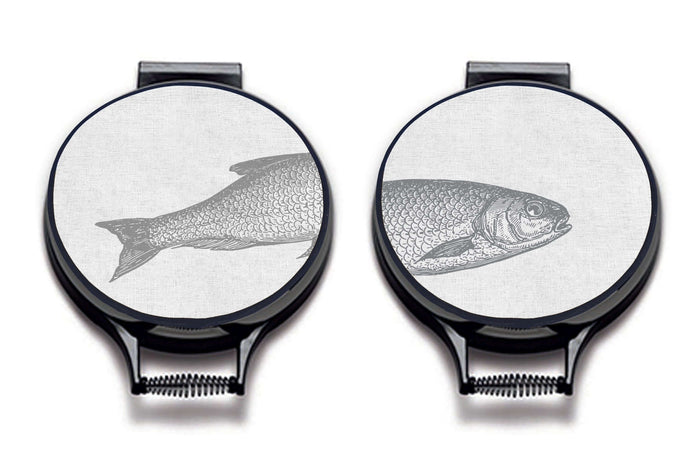 Set of two Ticklerton Aga Chef's Pads. Grey fish illustration print on a beige linen circular aga cover with black hemming. Fish head on one aga chef's pad and fish tail of the other aga chef's pad. Pictured on metal aga lid on an isolated background. Mustard and Gray
